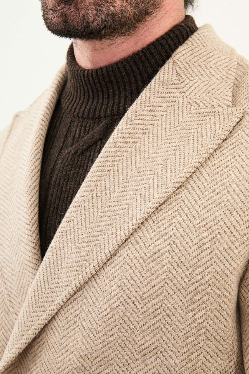 beige slim fit wide collar double-breasted coat, styled with a dark brown turtleneck sweater, front view.
