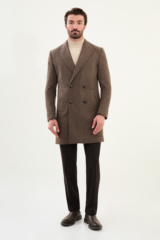 Full-body view of a man modeling a brown slim fit double-breasted coat with wide lapels, styled with dark trousers and brown Chelsea boots.