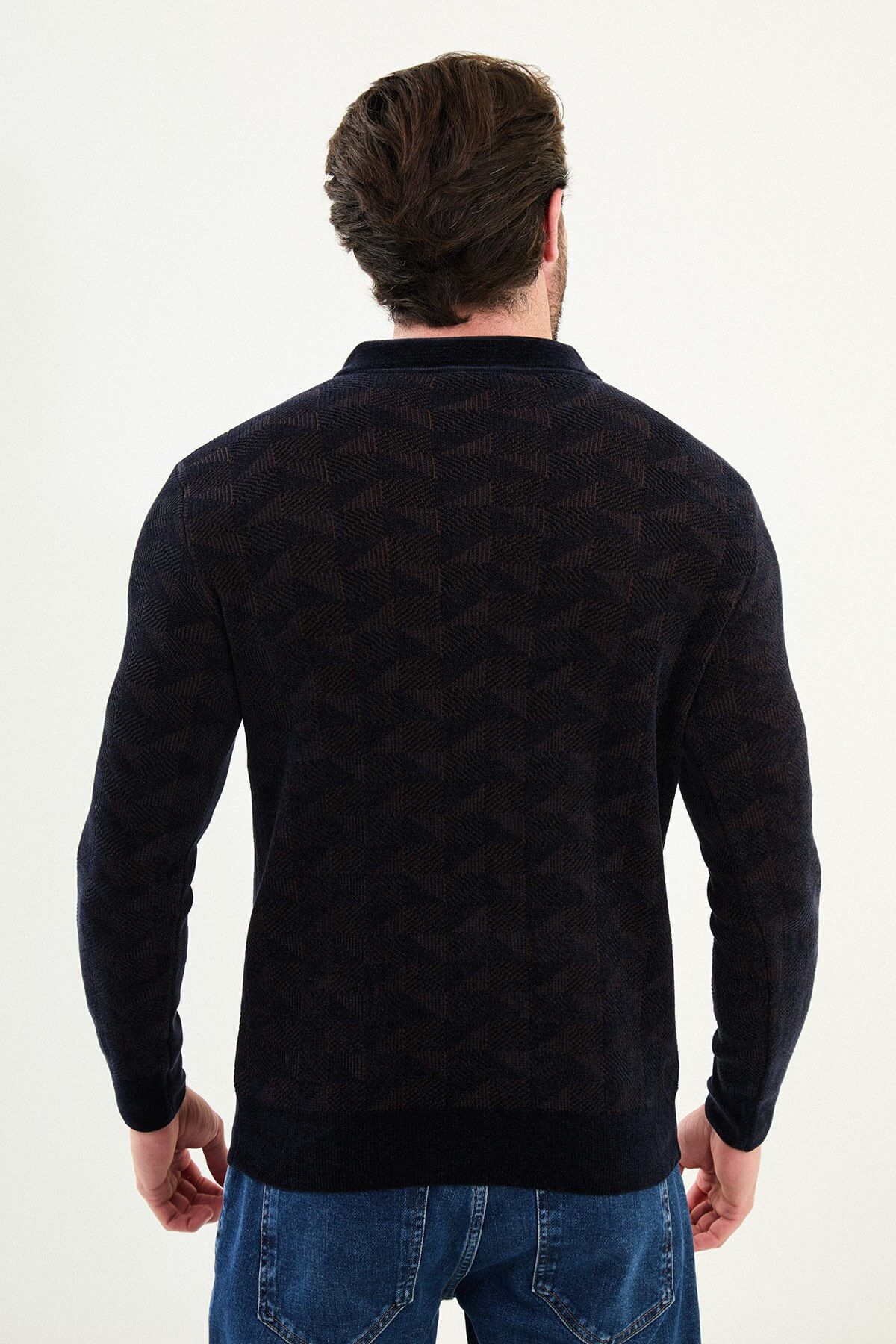 A man wearing a navy blue slim fit patterned knitwear sweater with a zippered polo collar.