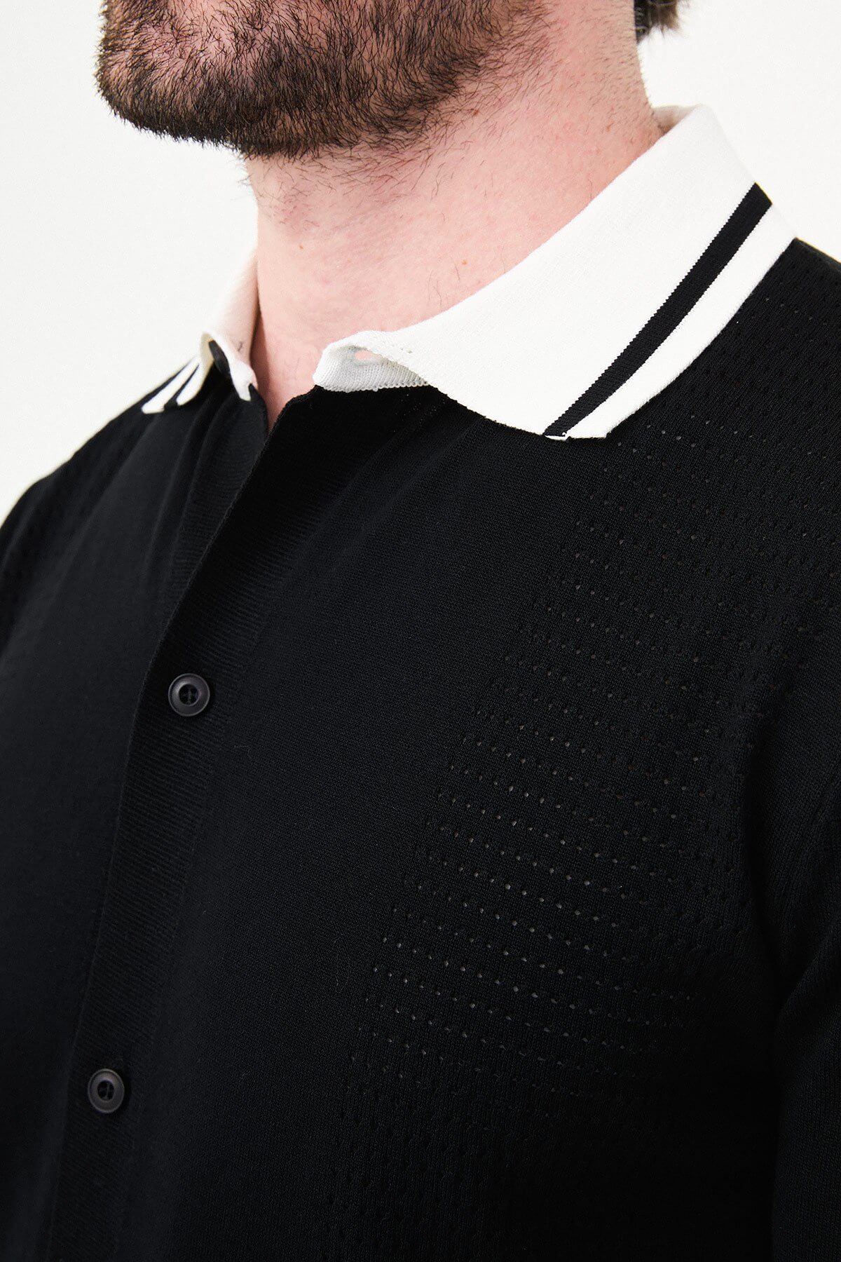Men’s black short sleeve knit polo shirt with button front, contrast collar, textured breathable fabric, slim fit smart casual style