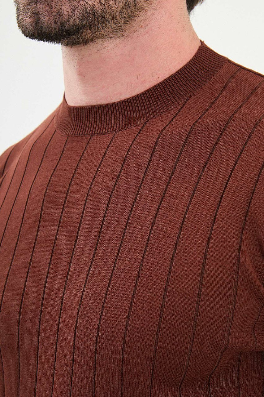 Model wearing AXIST tile brown ribbed knit sweater with beige chinos