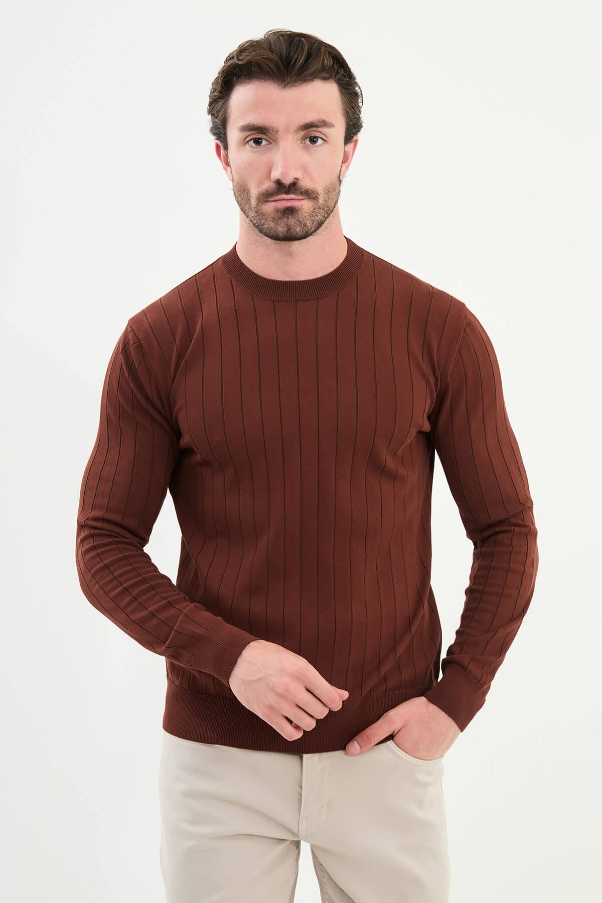 Model wearing AXIST tile brown ribbed knit sweater with beige chinos