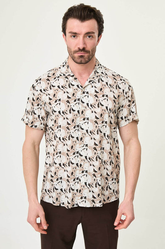 Men wearing a camel-patterned short-sleeved casual shirt, slim fit, standing with one hand in pocket, styled with dark trousers.
