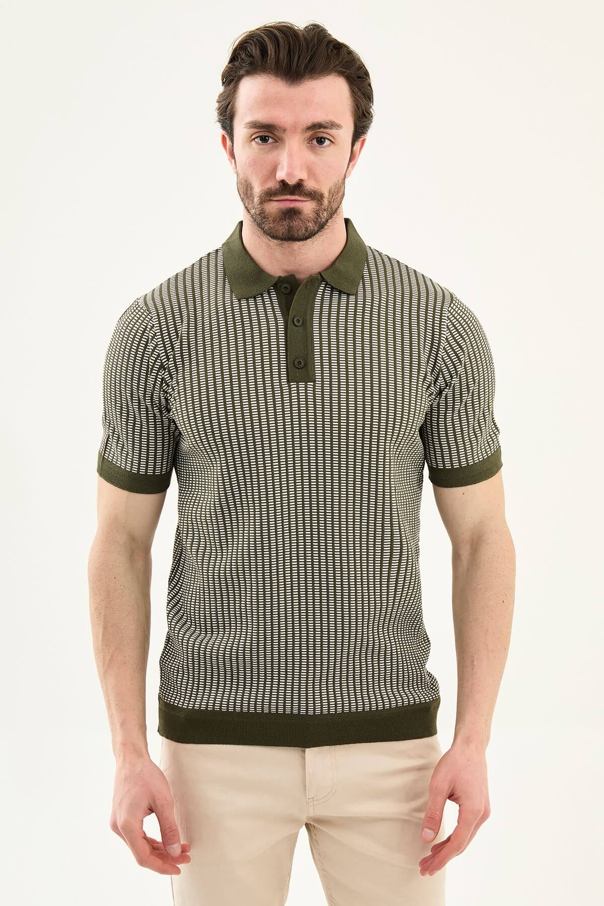 Men’s white striped slim fit knit polo shirt styled with dark trousers for an elegant summer smart-casual outfit.