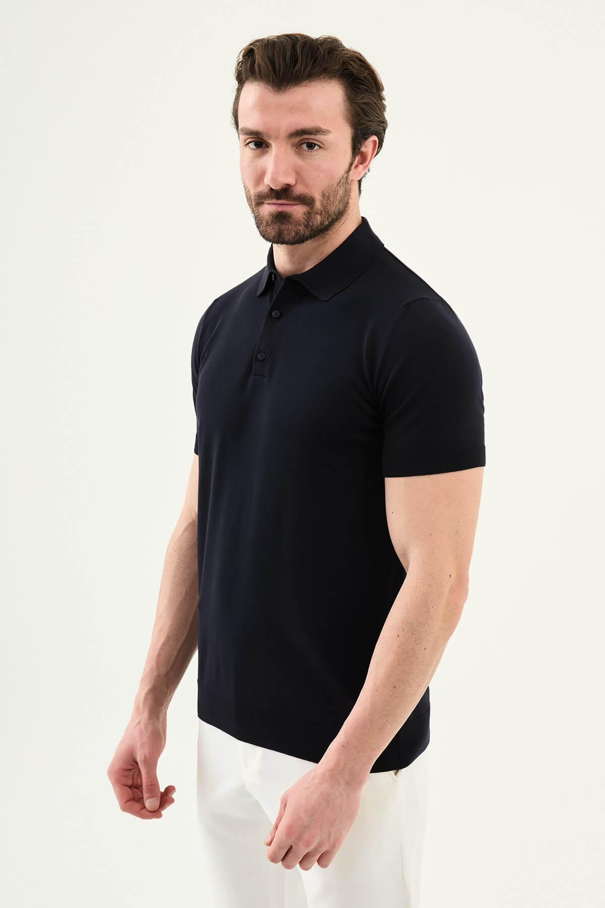 Men’s navy blue slim fit cotton polo shirt with short sleeves and stretch fabric, clean modern casual style