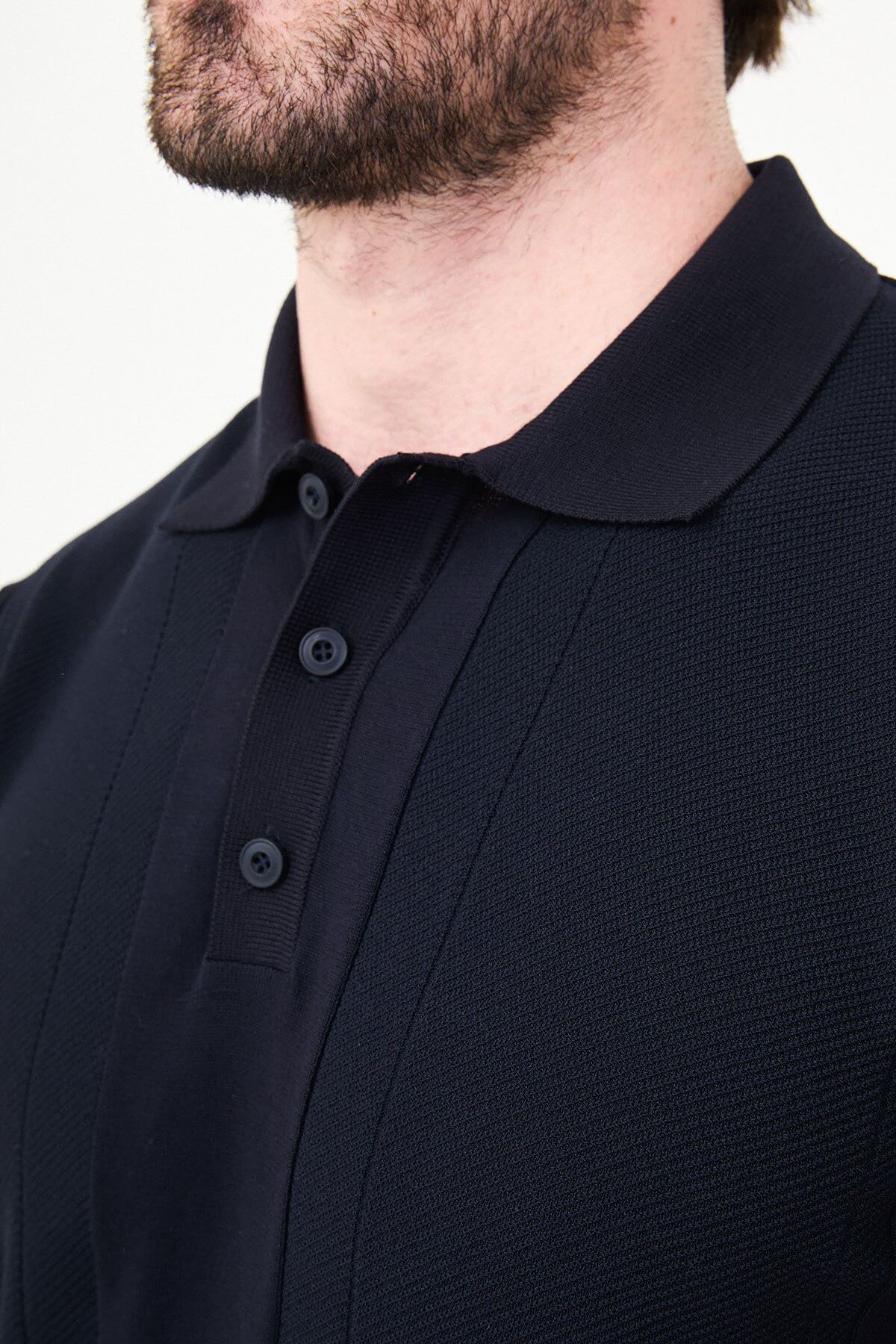 Men’s navy blue slim fit textured knit polo T-shirt with vertical panel design, short sleeves, classic collar, modern minimal style