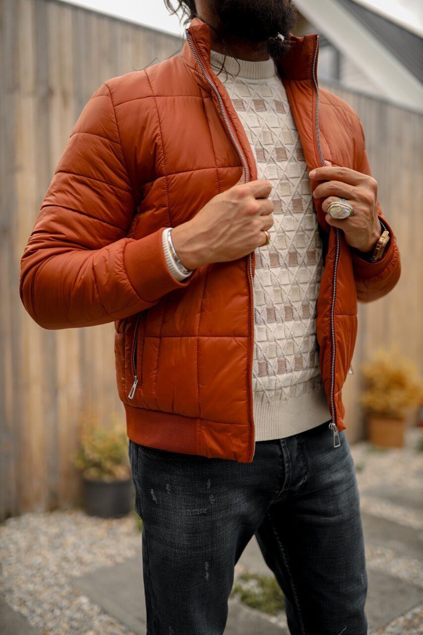 A men’s slim-fit tile zipper pocket detailed jacket paired with a patterned sweater and dark jeans, styled for a modern casual look.