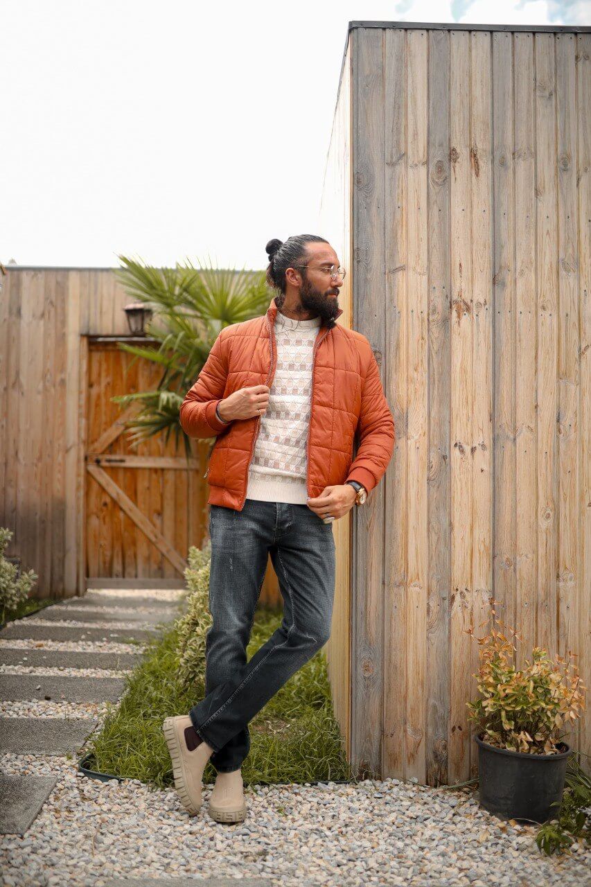 A men’s slim-fit tile zipper pocket detailed jacket paired with a patterned sweater and dark jeans, styled for a modern casual look.