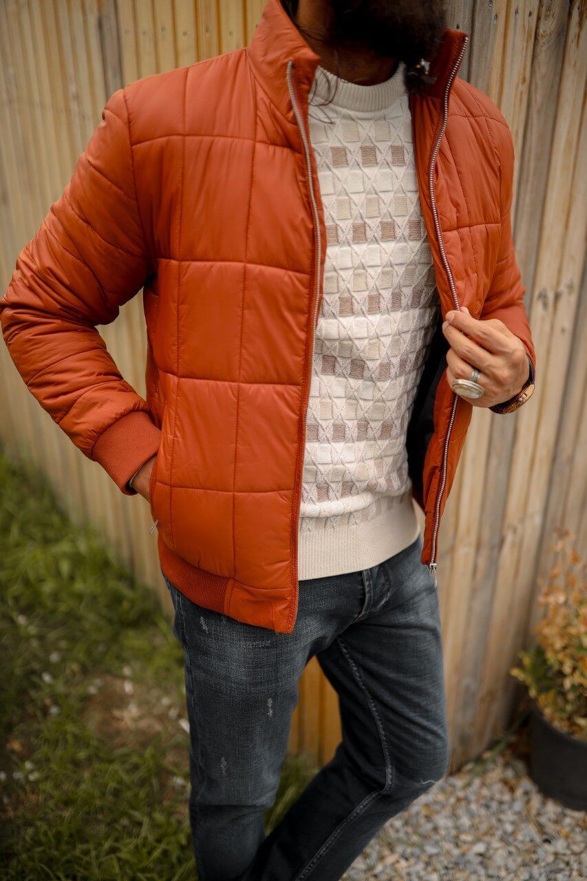 A men’s slim-fit tile zipper pocket detailed jacket paired with a patterned sweater and dark jeans, styled for a modern casual look.
