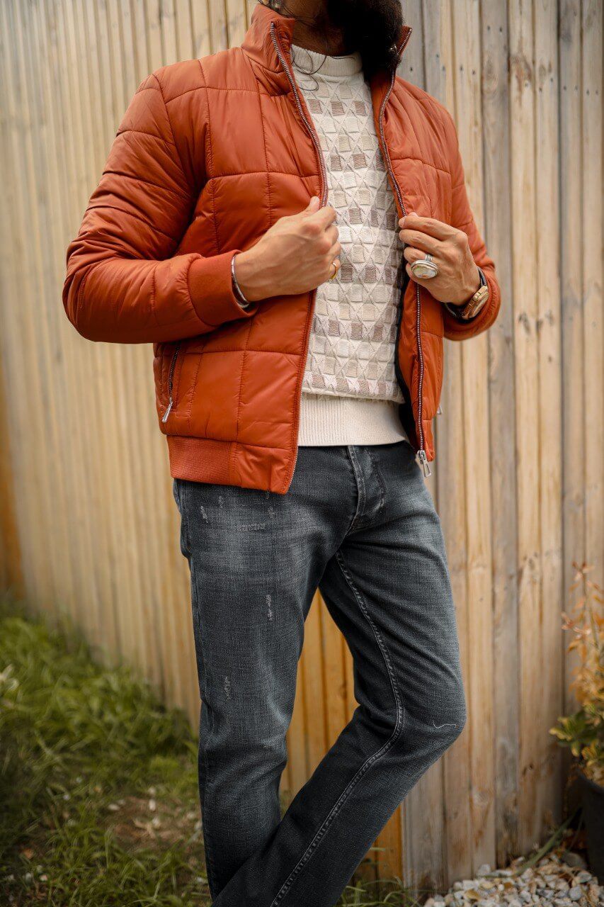 A men’s slim-fit tile zipper pocket detailed jacket paired with a patterned sweater and dark jeans, styled for a modern casual look.