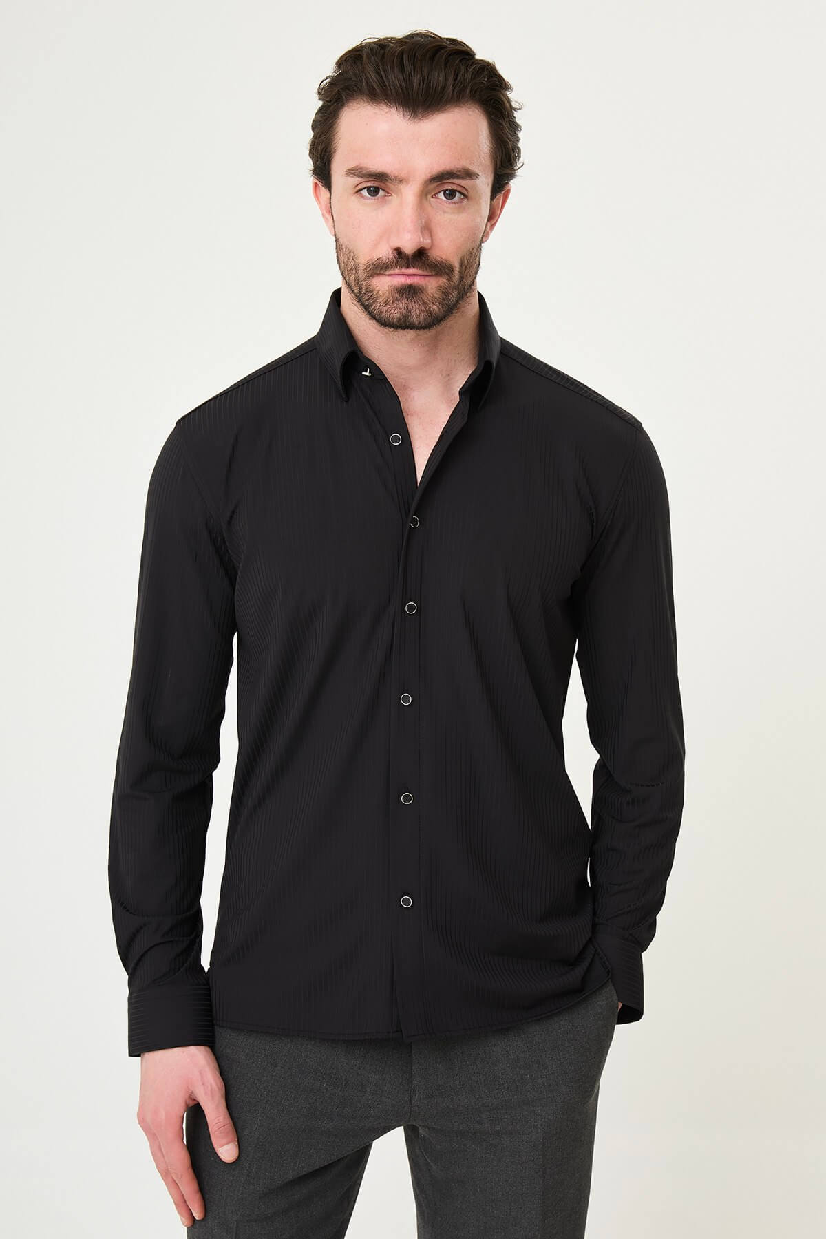Men wearing a black textured slim-fit long sleeve striped shirt, styled for smart-casual summer wear.