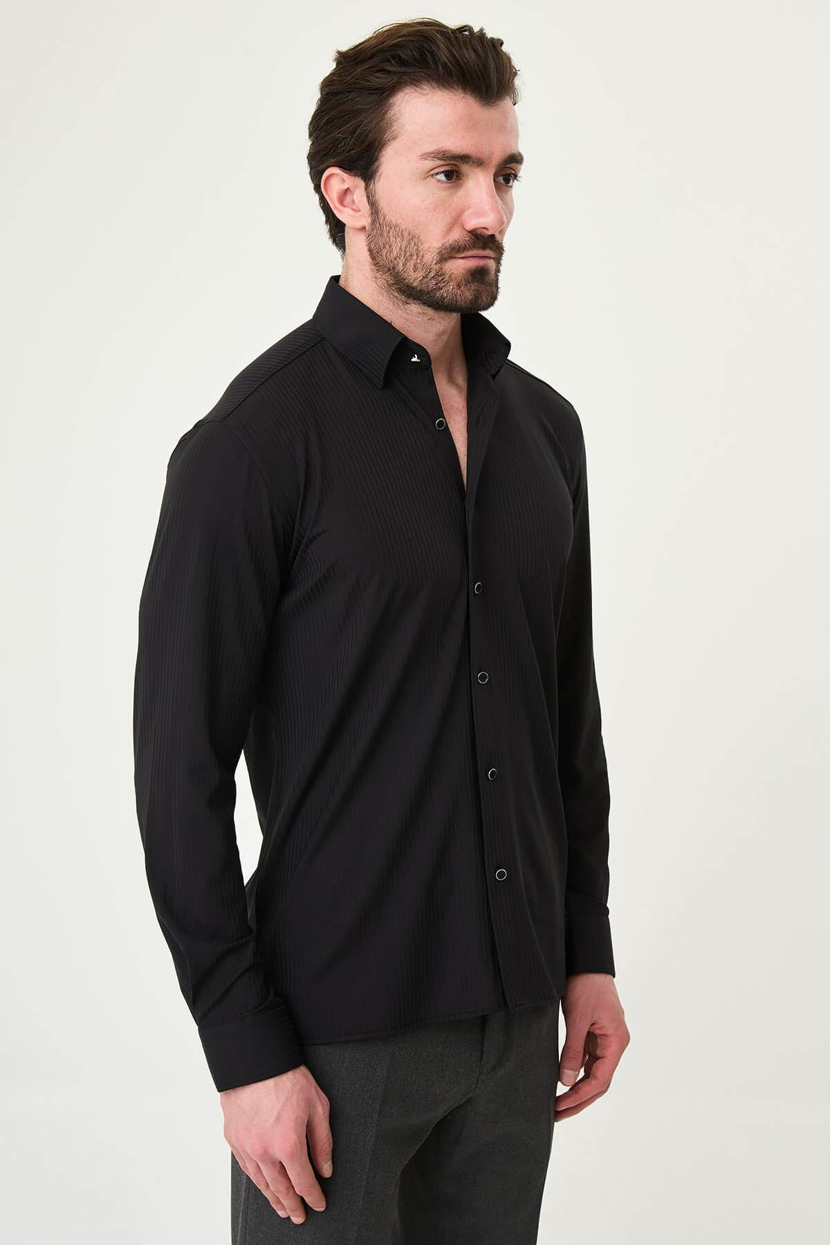 Men wearing a black textured slim-fit long sleeve striped shirt, styled for smart-casual summer wear.