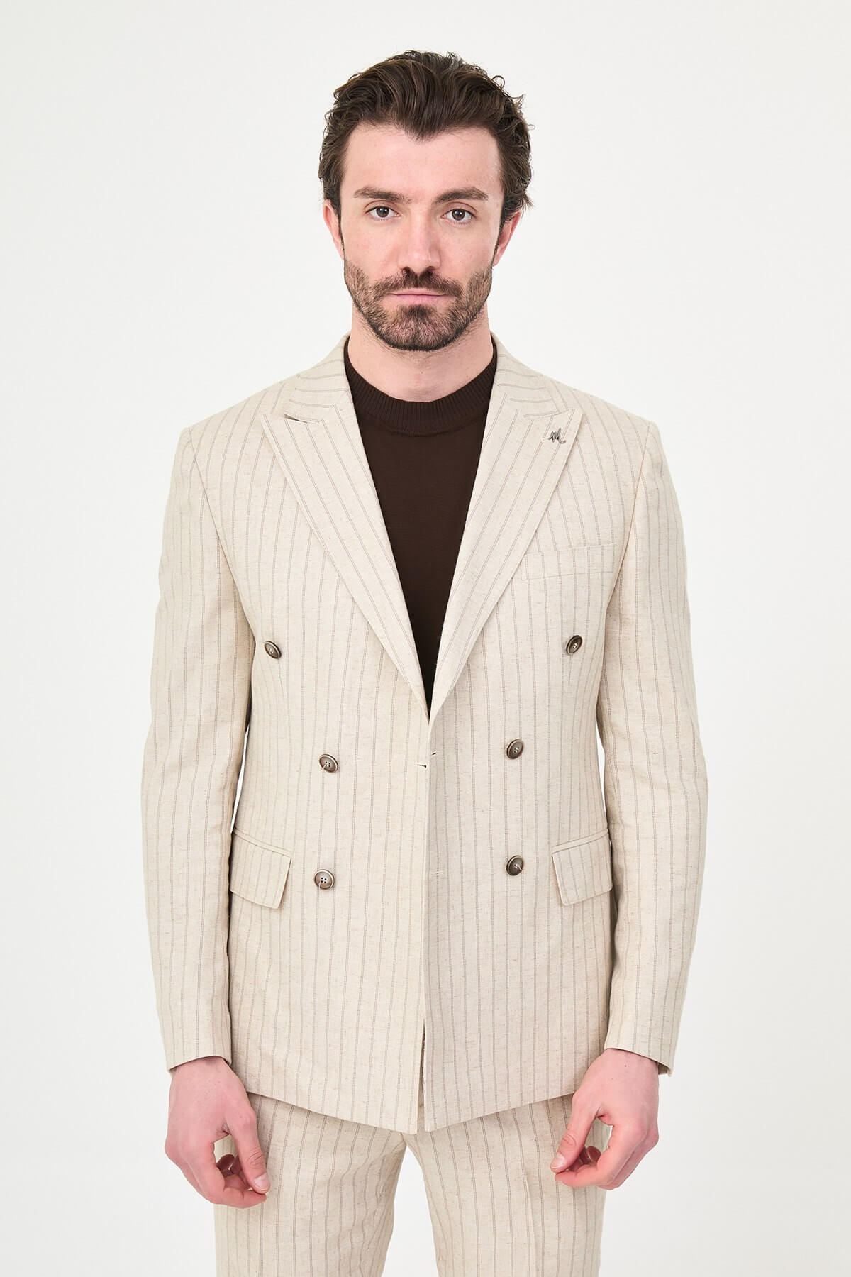 A man wearing a Beige Pinstripe Double-Breasted Slim-Fit Suit with a tailored fit, standing confidently.