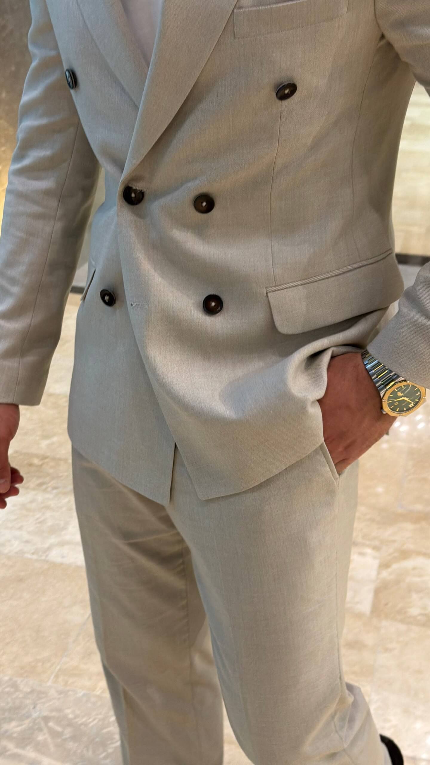 Men's beige double breasted suit with tailored jacket and matching trousers