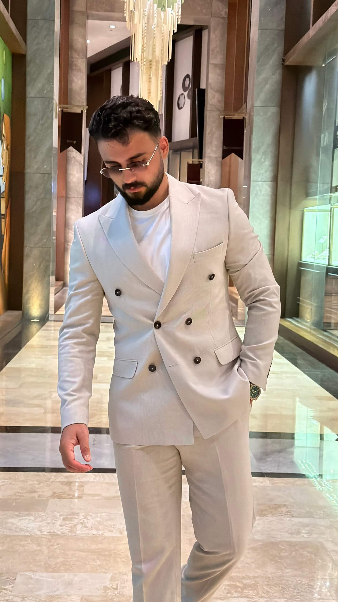 Men's beige double breasted suit with tailored jacket and matching trousers