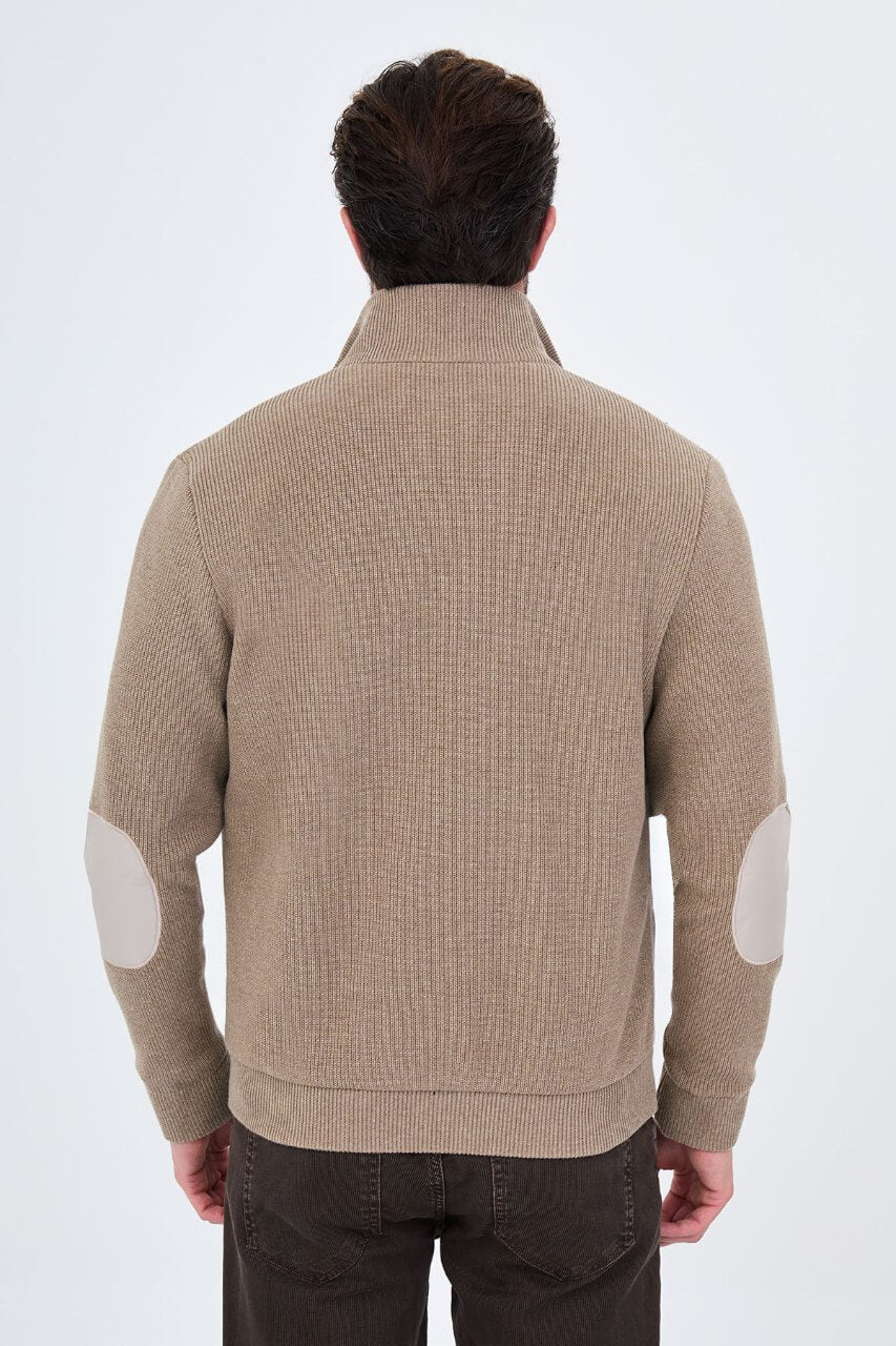 Beige men's casual jacket styled with a cream sweater and dark trousers.