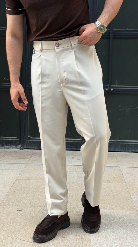 Beige pleated trousers with tapered hem, back view