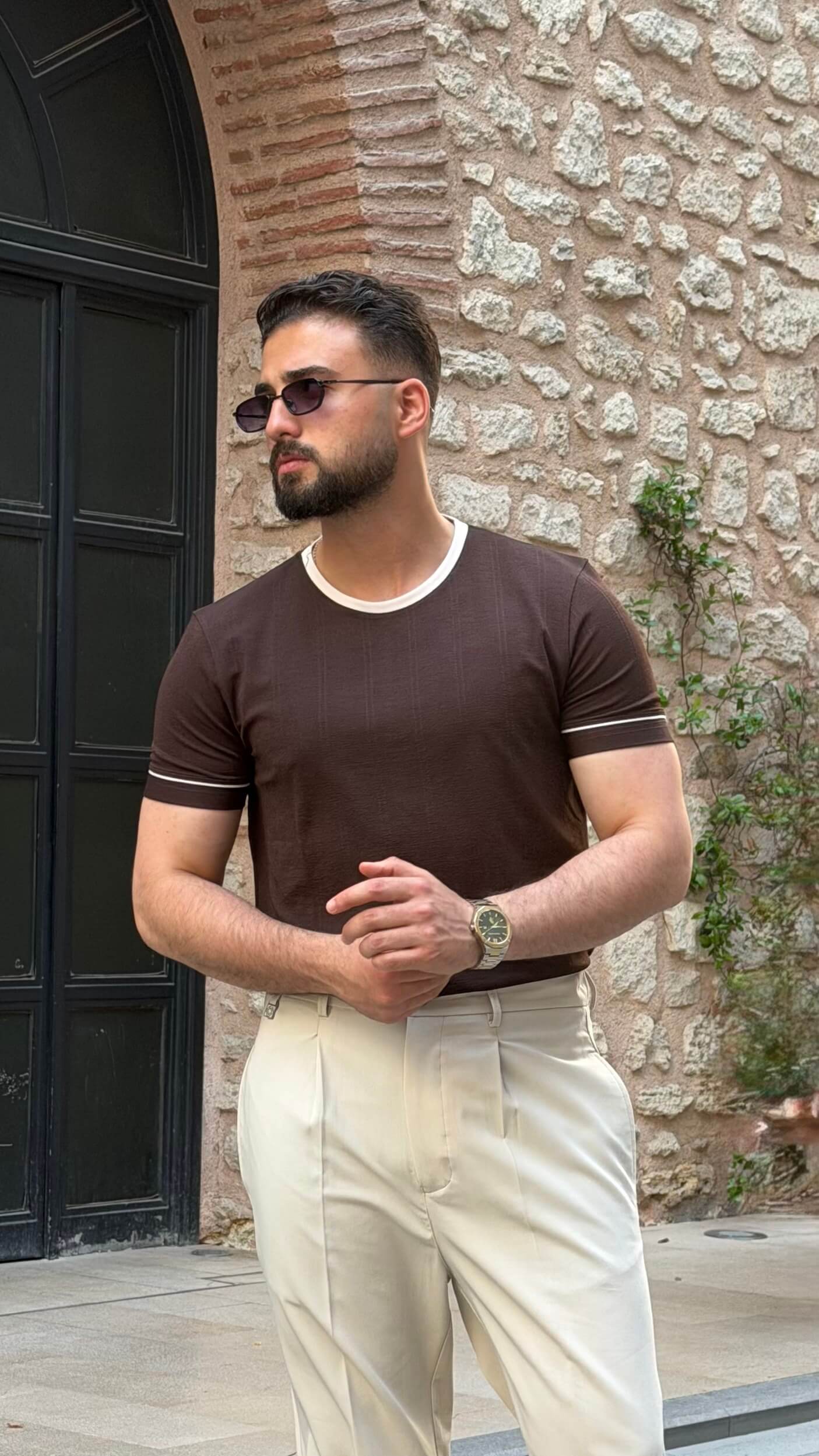 Beige pleated tailored trousers, side view
