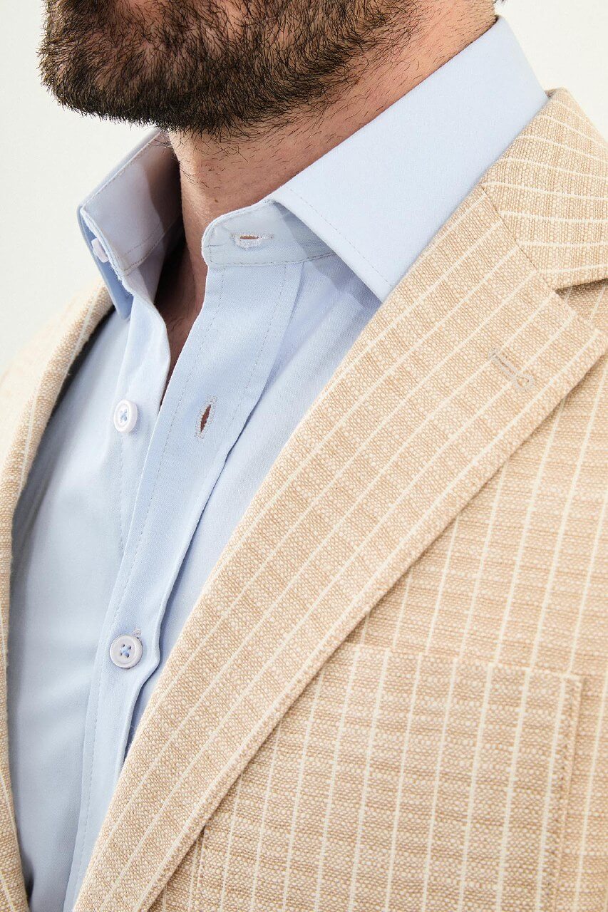 Men’s beige slim fit cotton linen blazer with a lightweight textured finish, tailored for smart casual and formal summer styling.