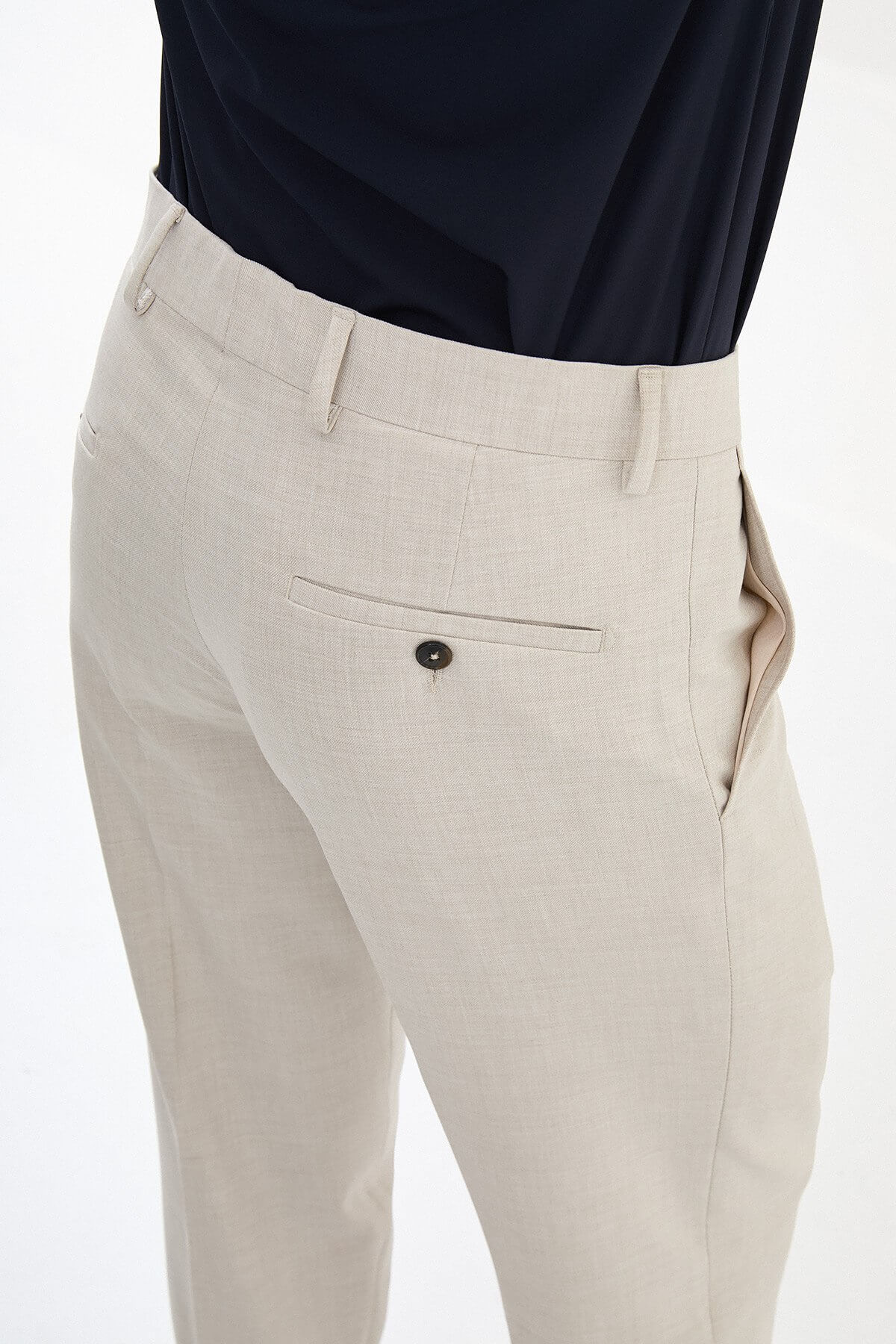 Men wearing beige slim-fit classic trousers, paired with formal shoes and a dress shirt, suitable for office and formal events.