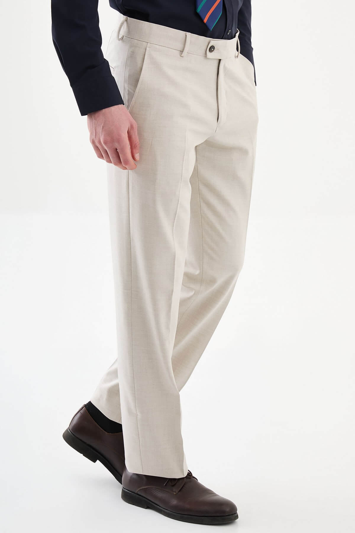 Men wearing beige slim-fit classic trousers, paired with formal shoes and a dress shirt, suitable for office and formal events.