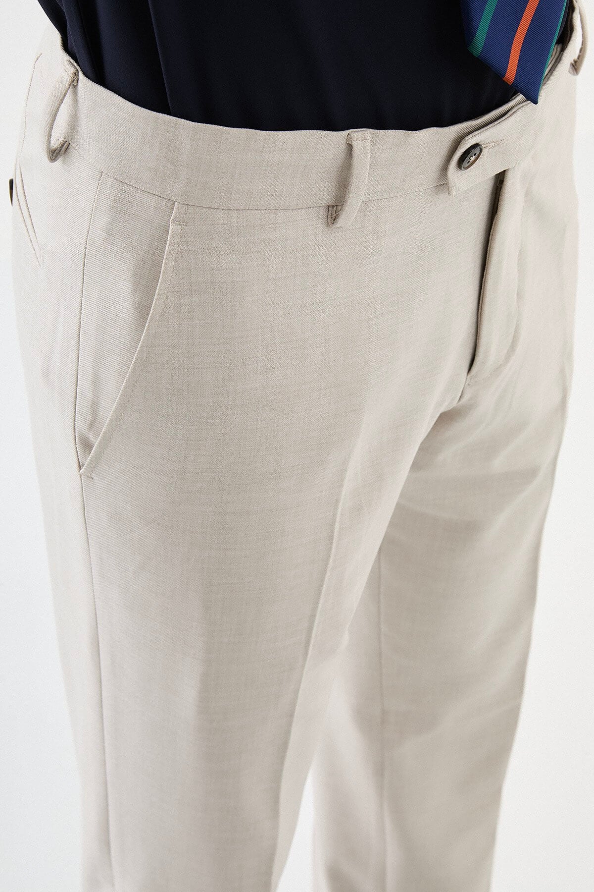 Men wearing beige slim-fit classic trousers, paired with formal shoes and a dress shirt, suitable for office and formal events.
