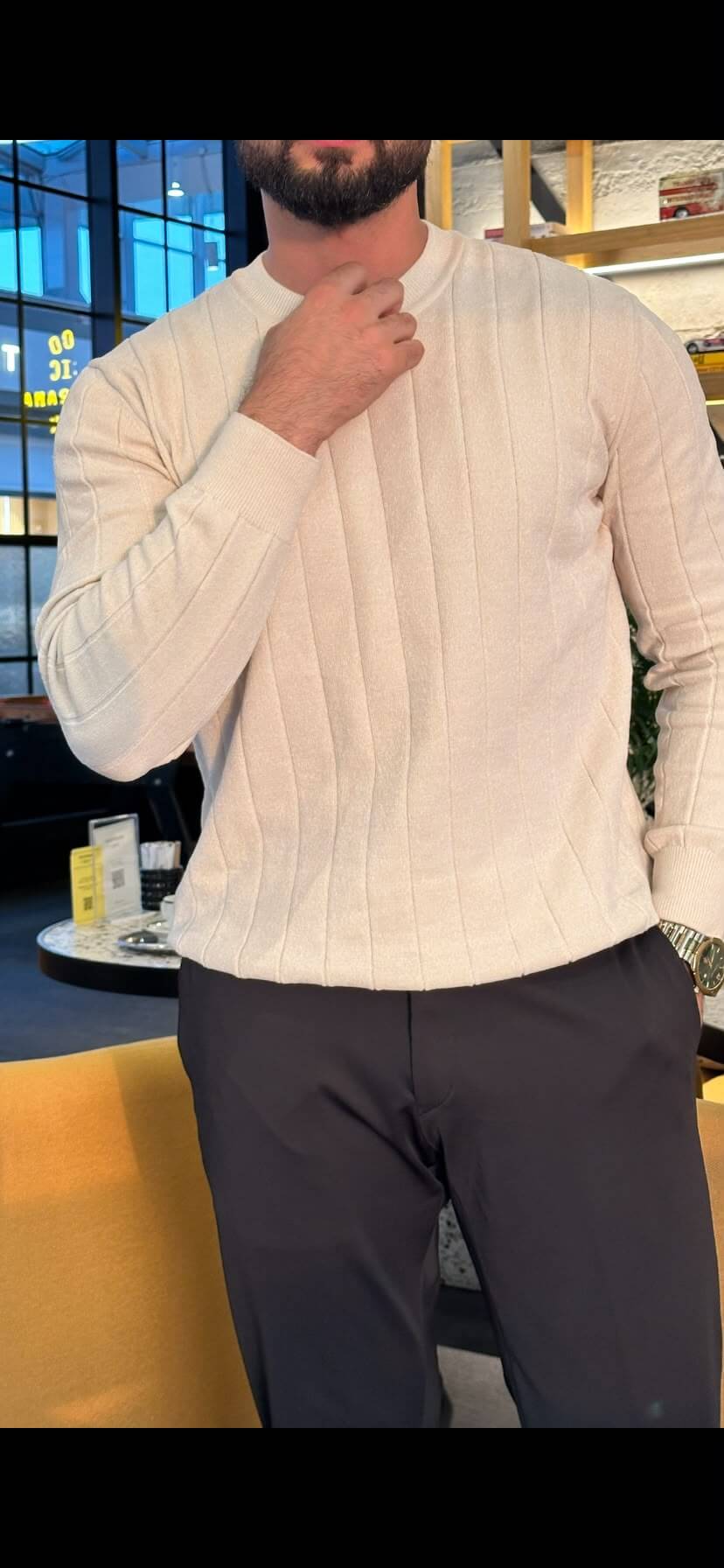 Men’s ecru ribbed crewneck cotton sweater styled with black trousers for fall winter fashion
