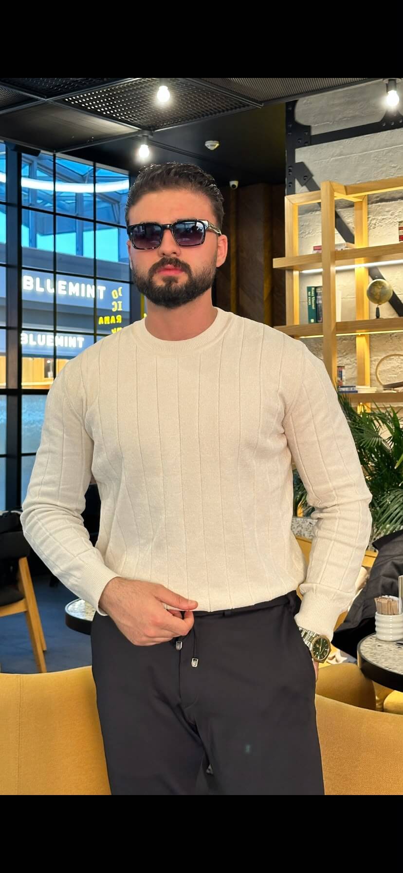 Men’s ecru ribbed crewneck cotton sweater styled with black trousers for fall winter fashion