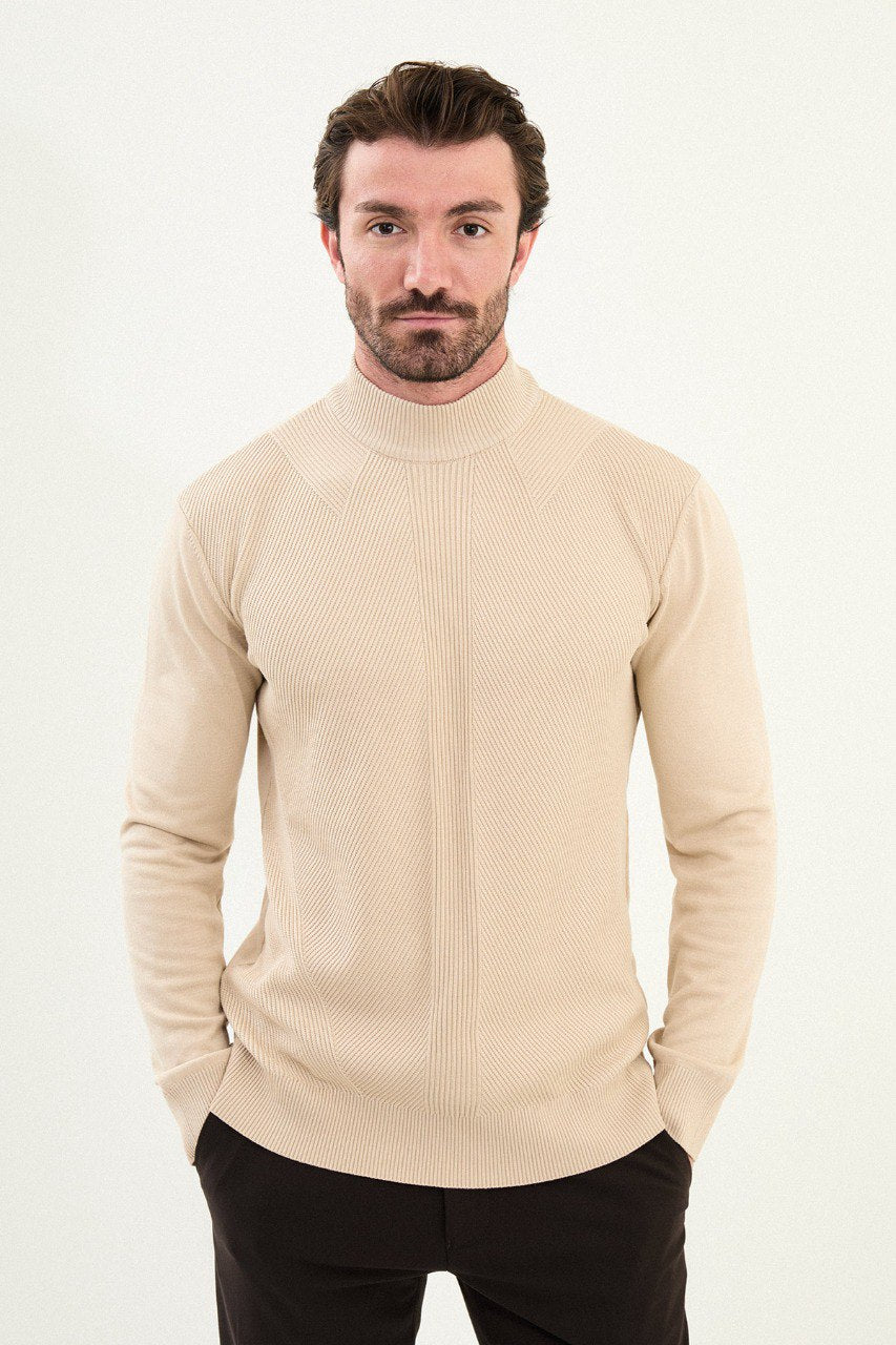 Men’s beige slim-fit ribbed mock-neck cotton-blend sweater with multi-directional ribbing and diagonal chest panels, styled with dark trousers.