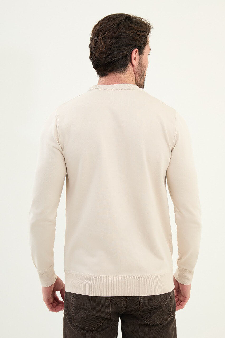 Men’s beige slim-fit crew-neck sweater with geometric ‘T’ textured knit front panel, ribbed collar, cotton-viscose-elastane blend, styled with dark corduroy trousers.