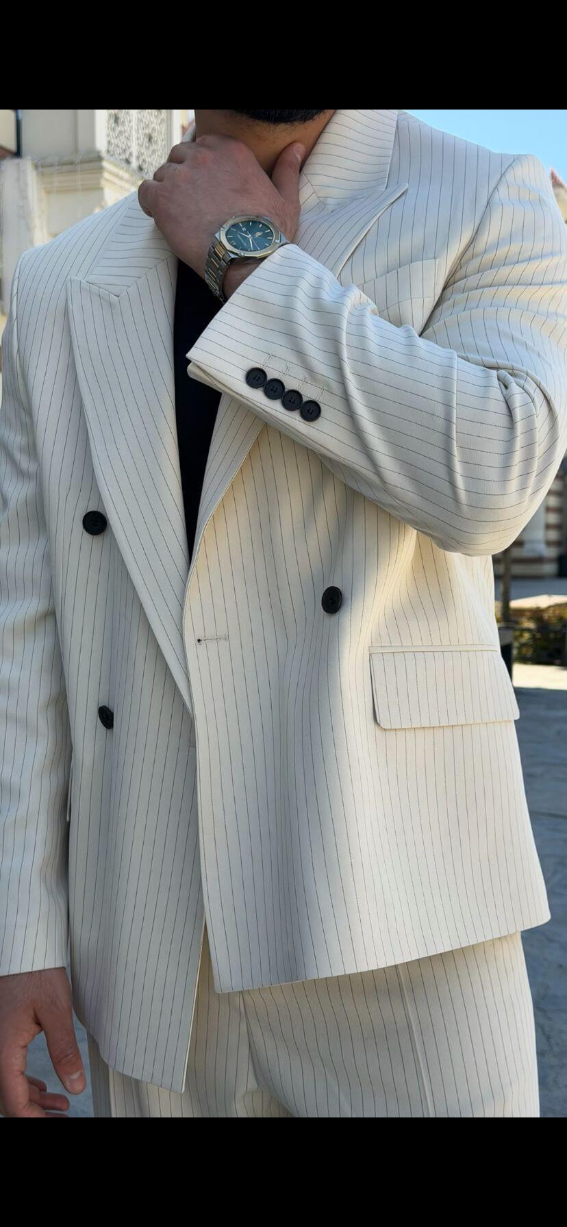 Men wearing beige shawl lapel slim-fit suit with matching trousers, styled outdoors, front view.