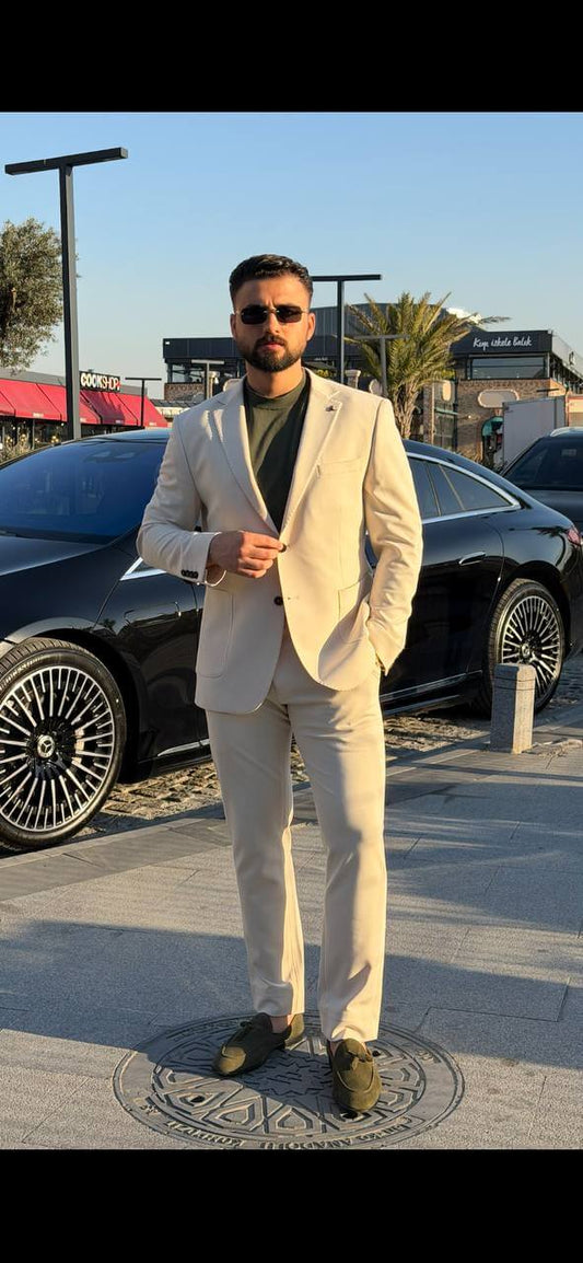 Beige 2 piece slim fit suit with matching blazer and olive loafers, front view