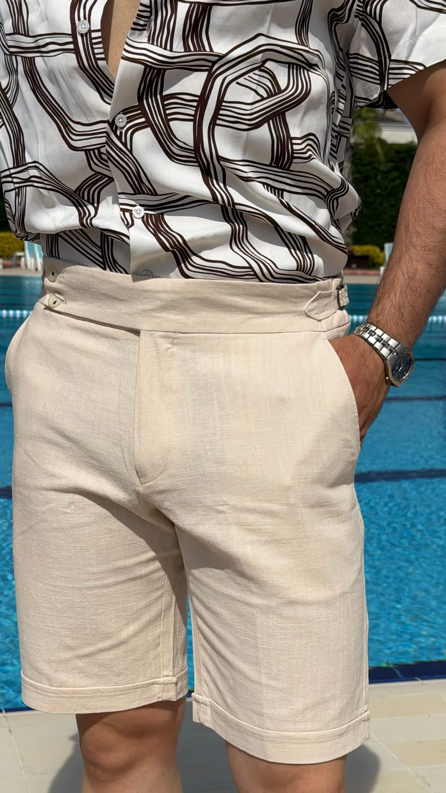 Men’s beige slim fit linen shorts with tailored design, lightweight fabric, button closure, and elegant summer casual style.