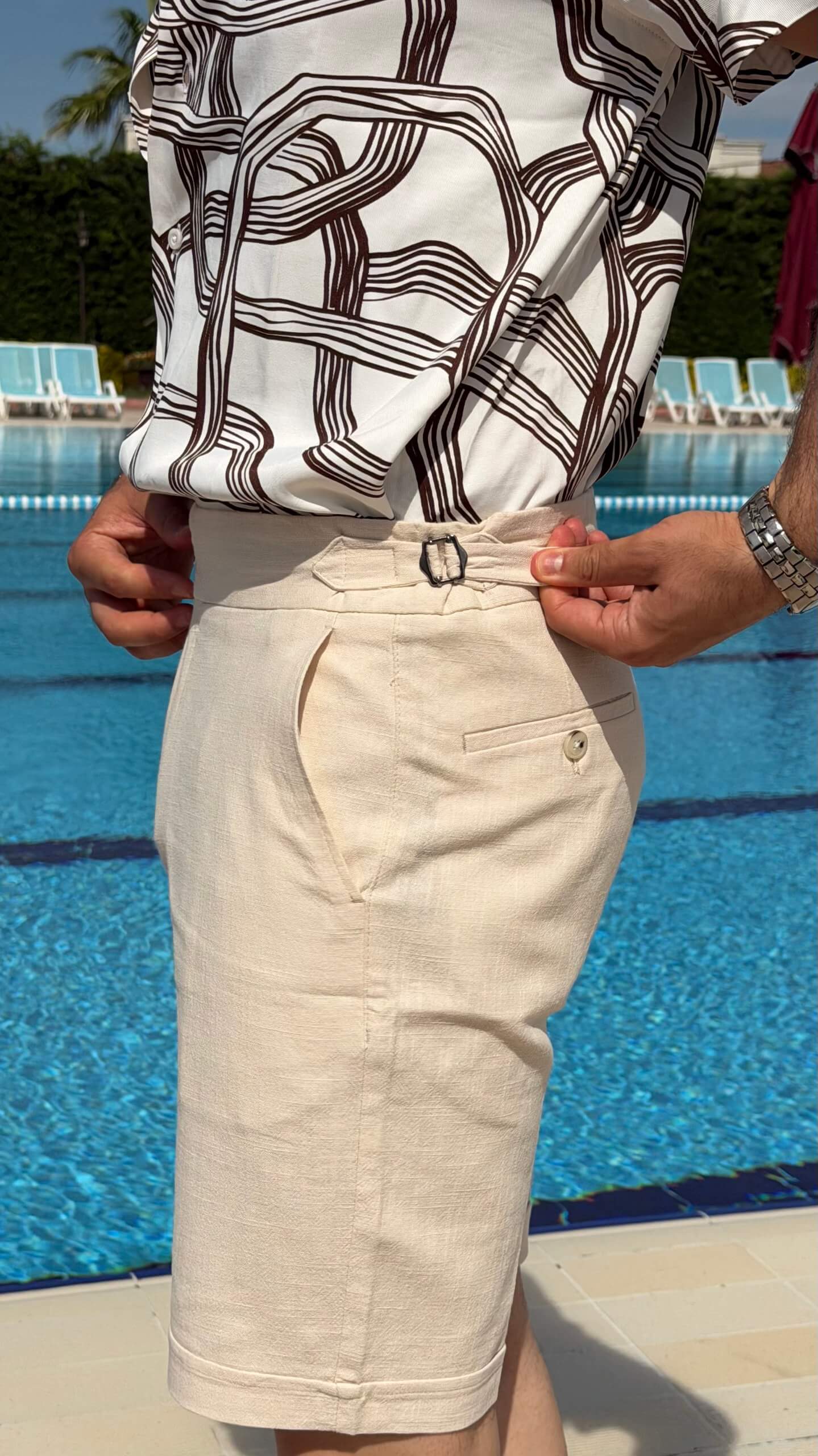 Men’s beige slim fit linen shorts with tailored design, lightweight fabric, button closure, and elegant summer casual style.