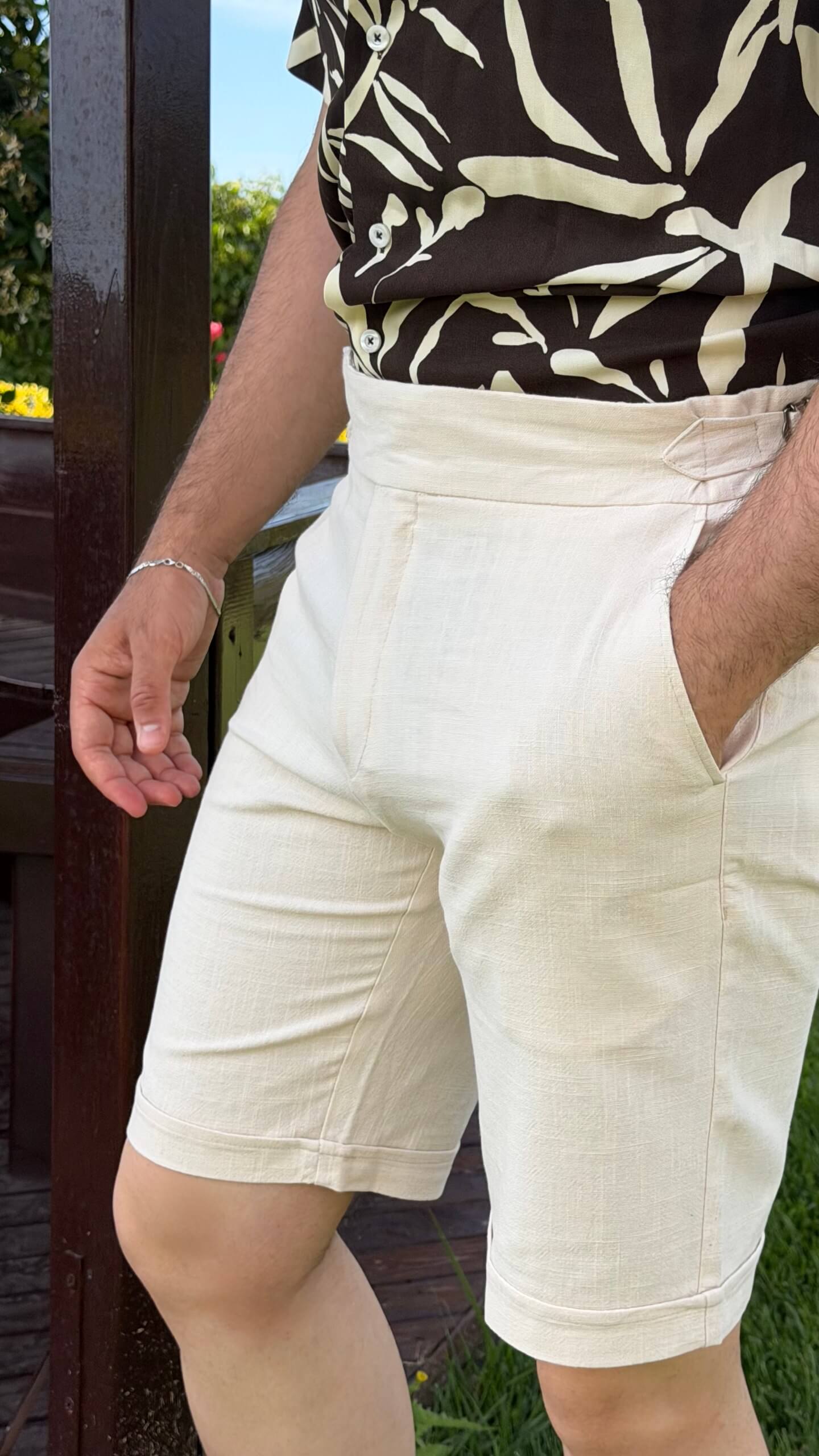 Men’s beige slim fit linen shorts with tailored design, lightweight fabric, button closure, and elegant summer casual style.
