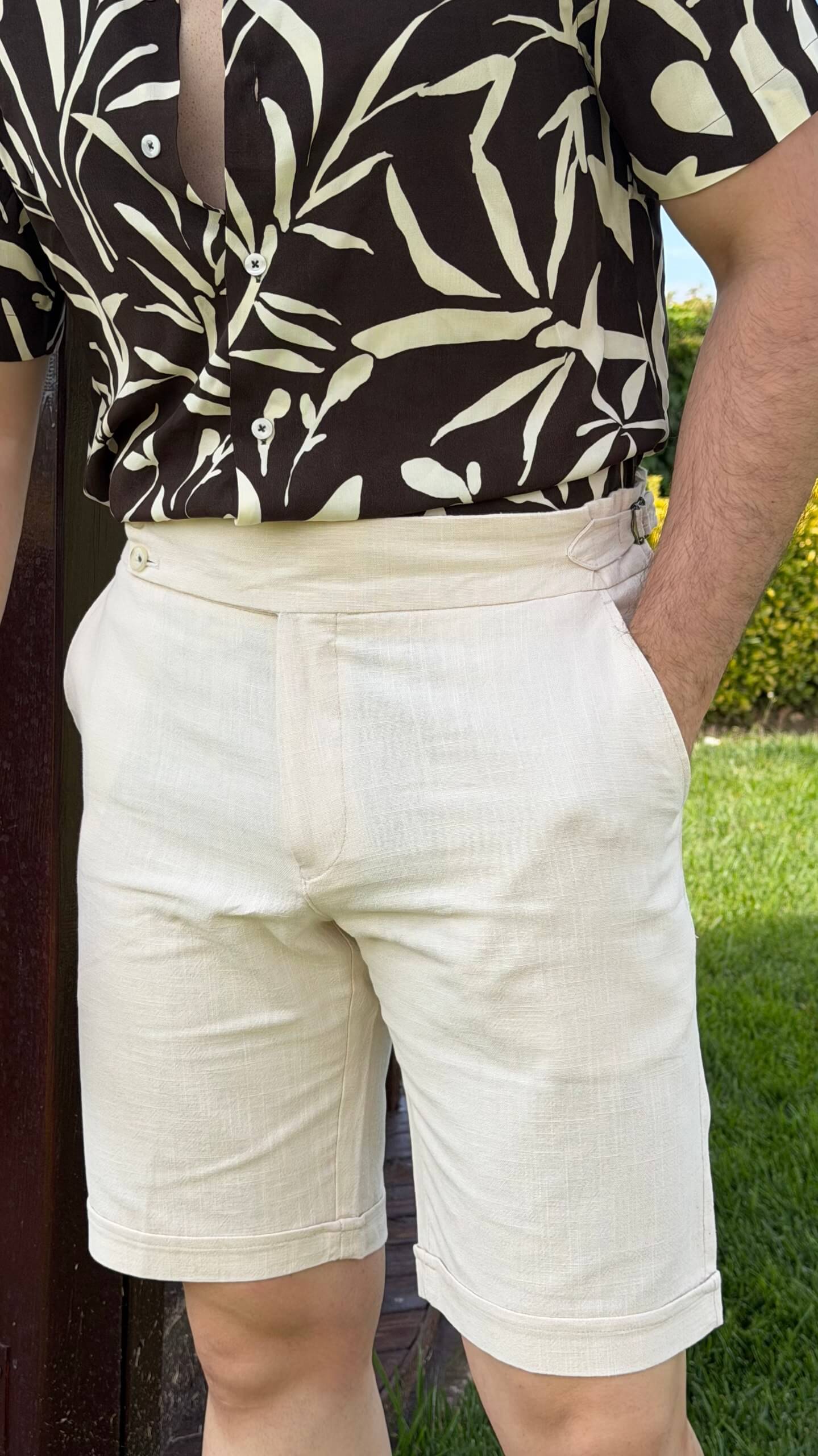 Men’s beige slim fit linen shorts with tailored design, lightweight fabric, button closure, and elegant summer casual style.