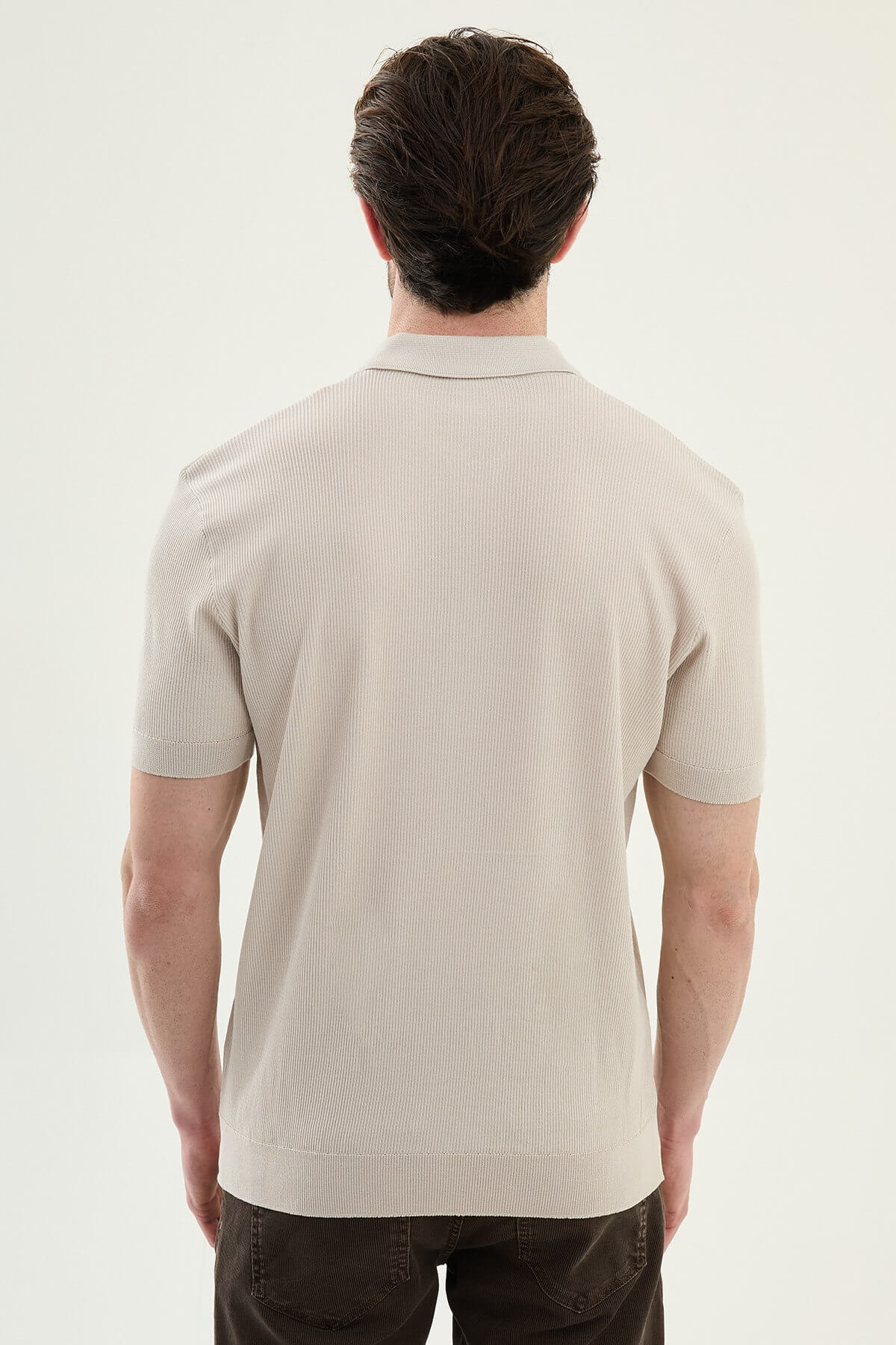 Men’s beige slim-fit knit polo shirt with classic collar, short sleeves, and textured knit finish for summer smart-casual style.