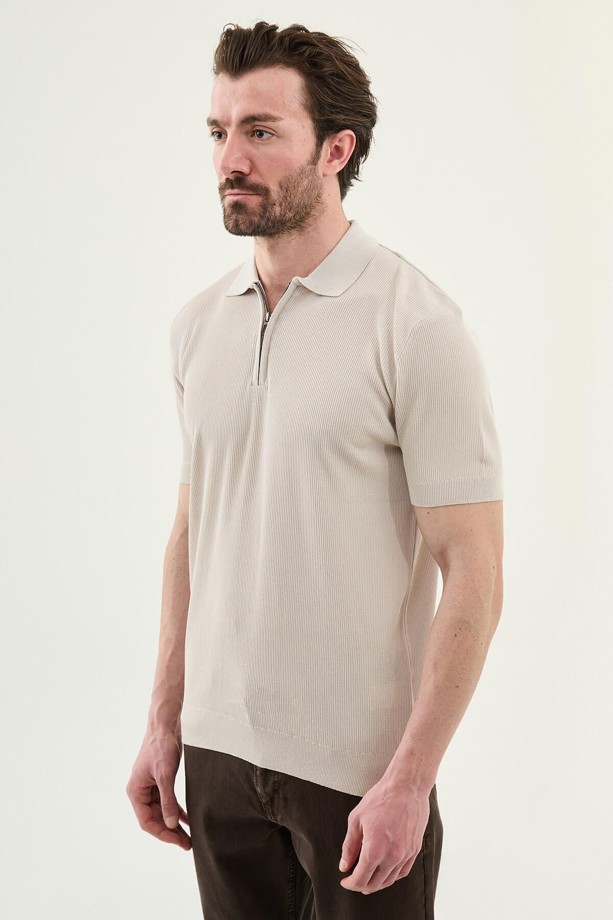 Men’s beige slim-fit knit polo shirt with classic collar, short sleeves, and textured knit finish for summer smart-casual style.