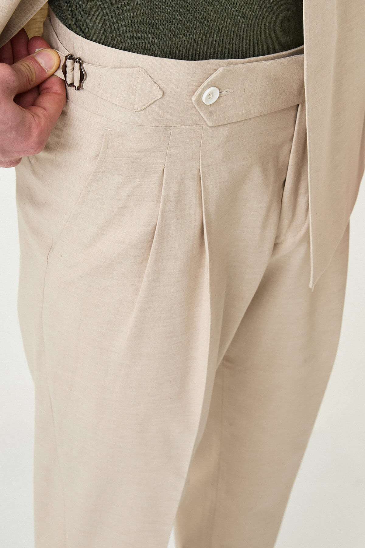 Men wearing Beige Slim-Fit Suit from neck down, paired with olive sneakers