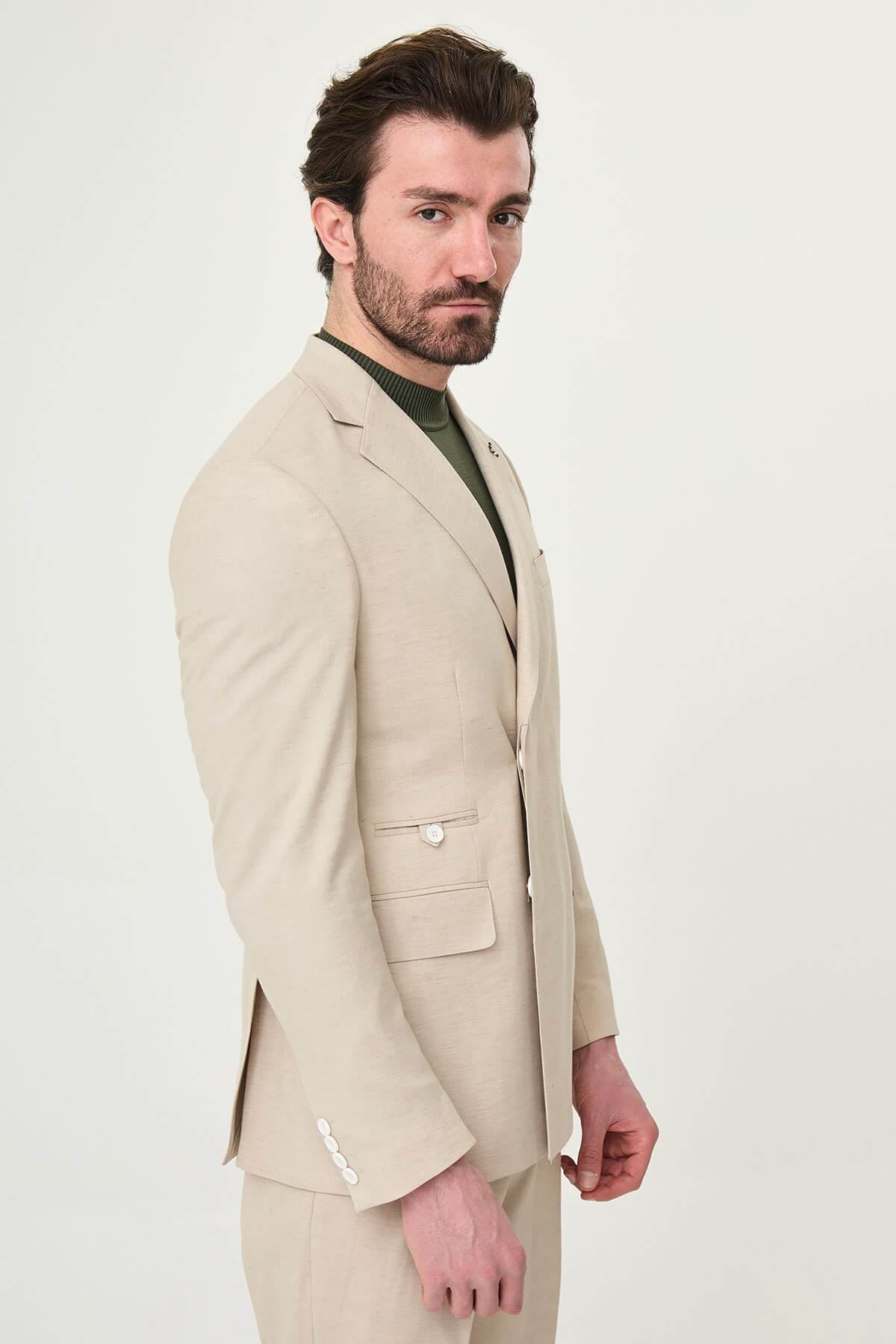 Men wearing Beige Slim-Fit Suit from neck down, paired with olive sneakers