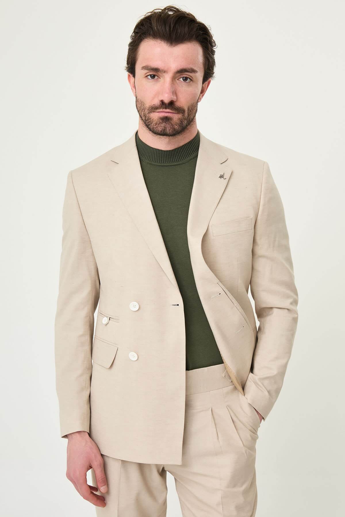 Men wearing Beige Slim-Fit Suit from neck down, paired with olive sneakers