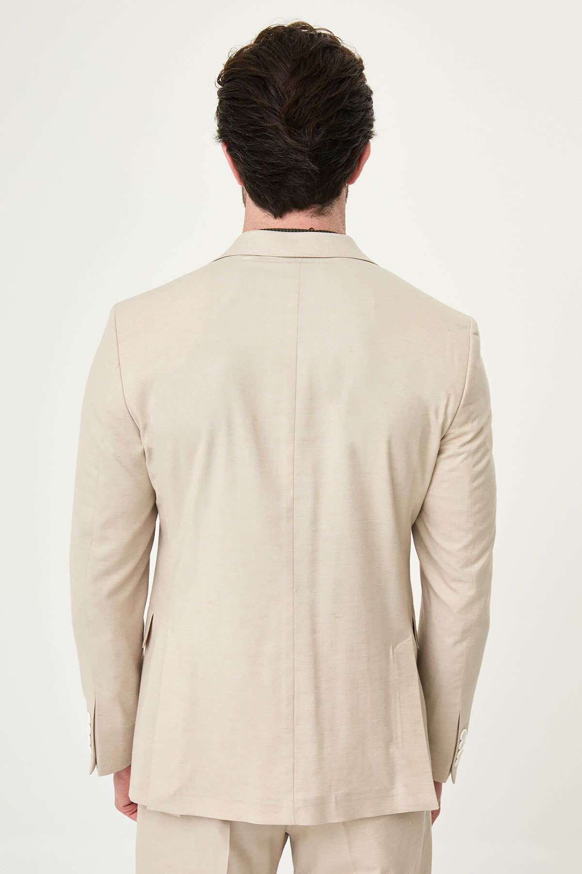 Men wearing Beige Slim-Fit Suit from neck down, paired with olive sneakers