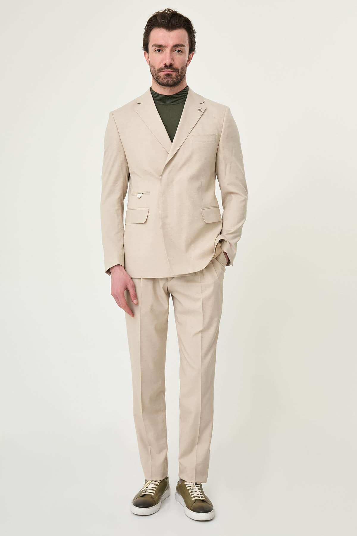 Men wearing Beige Slim-Fit Suit from neck down, paired with olive sneakers