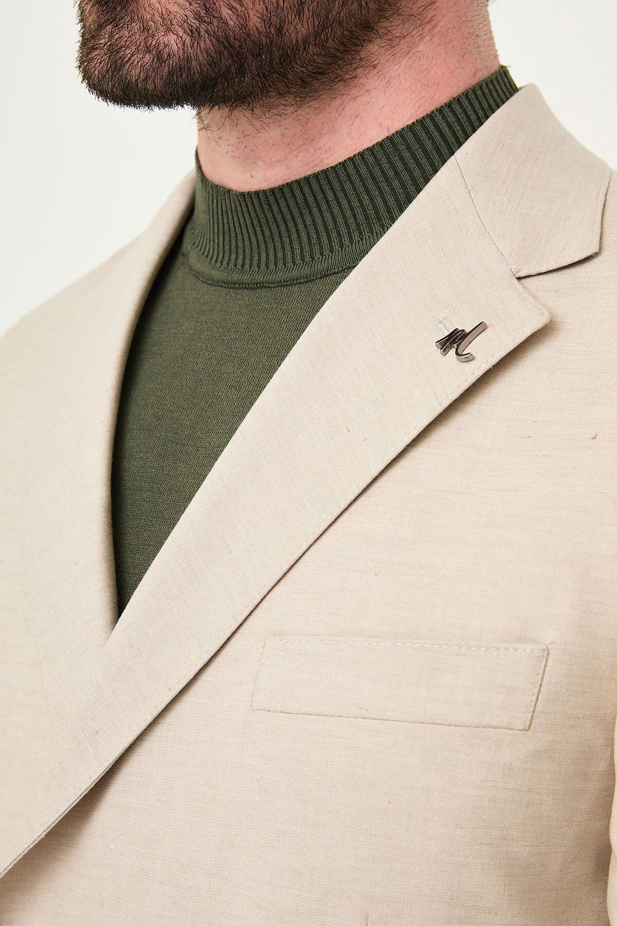 Men wearing Beige Slim-Fit Suit from neck down, paired with olive sneakers