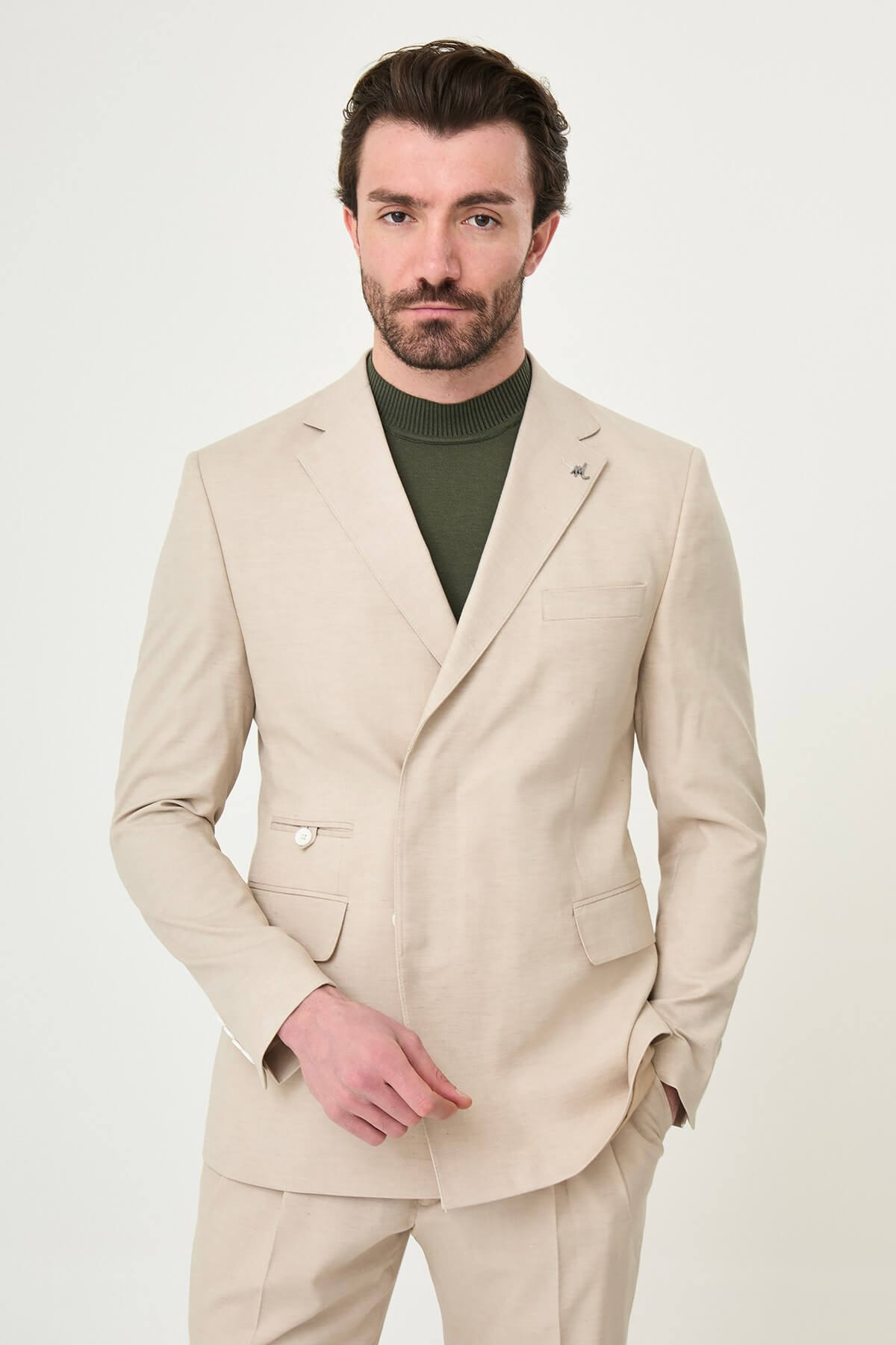 Men wearing Beige Slim-Fit Suit from neck down, paired with olive sneakers