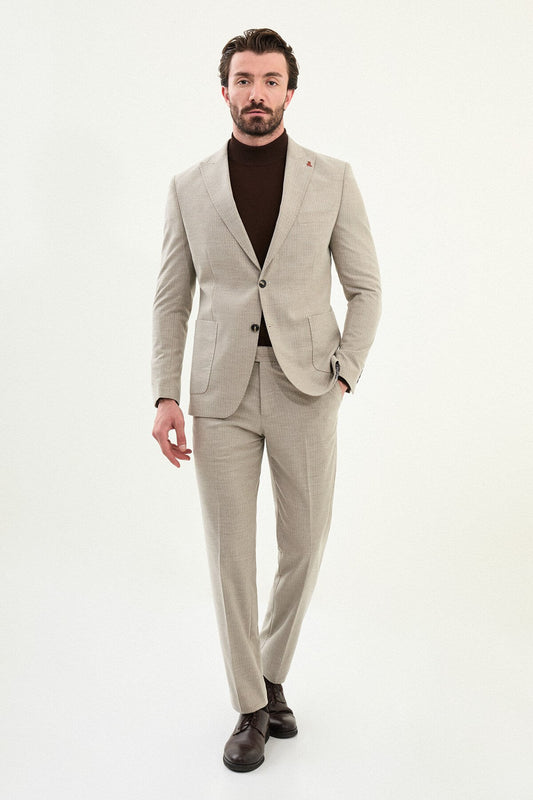 Men’s beige slim-fit mono-collar (mandarin collar) winter suit with minimalist single-breasted jacket, matte micro-texture active-recovery fabric, styled with a dark brown turtleneck.