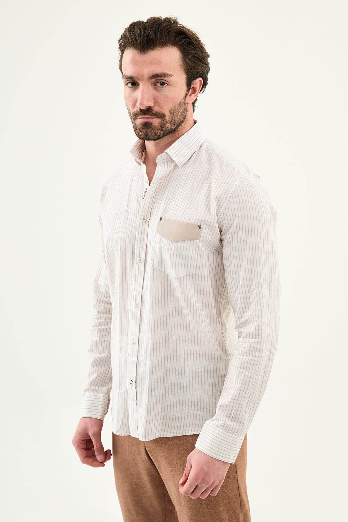 beige slim-fit long sleeve shirt with subtle stripe detailing, pocket accent, and tailored cuffs, paired with light trousers
