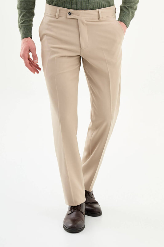 Beige slim-fit formal trousers with subtle pleats, styled with dress shoes, perfect for summer smart-casual and formal occasions.