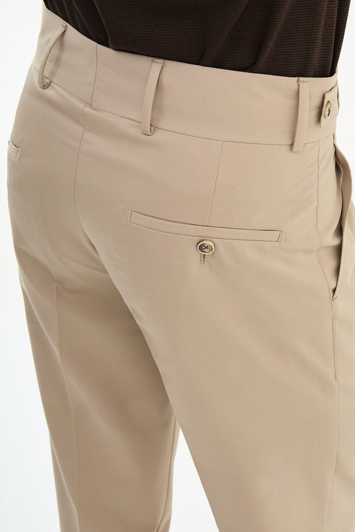 Beige slim-fit straight-leg pleated trousers for men, styled with brown leather shoes, ideal for summer business and formal occasions.