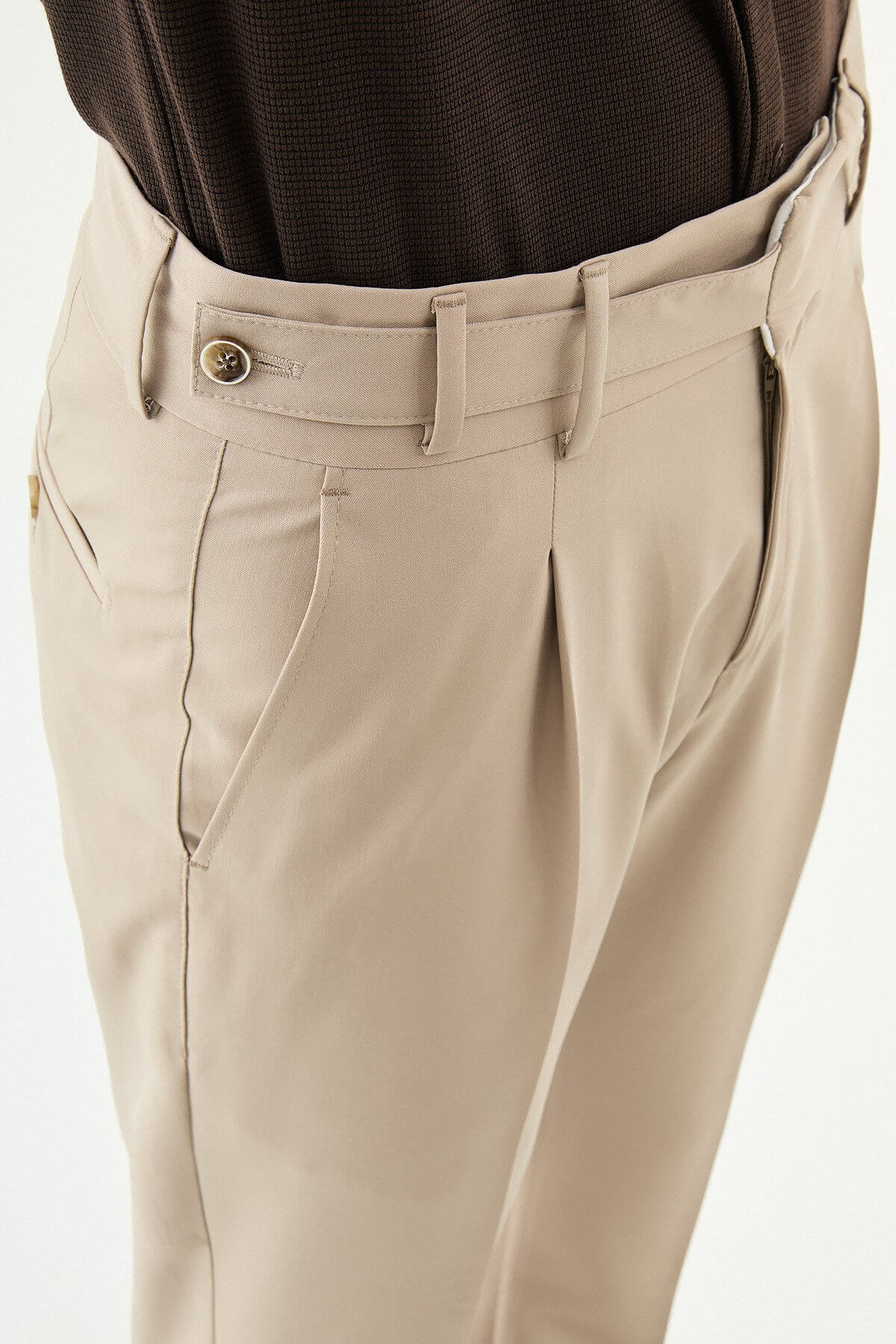 Beige slim-fit straight-leg pleated trousers for men, styled with brown leather shoes, ideal for summer business and formal occasions.